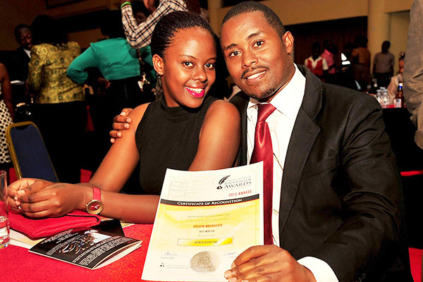 Monitor sports reporter  Andrew Mwanguhya (L) poses for a picture with a friend.