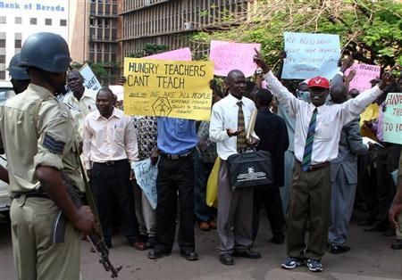 Ugandan teachers hold banners and shout slogans during a demonstration in Kampala June 15, 2005 in a protest against the government's failure to pay them a strike recently.