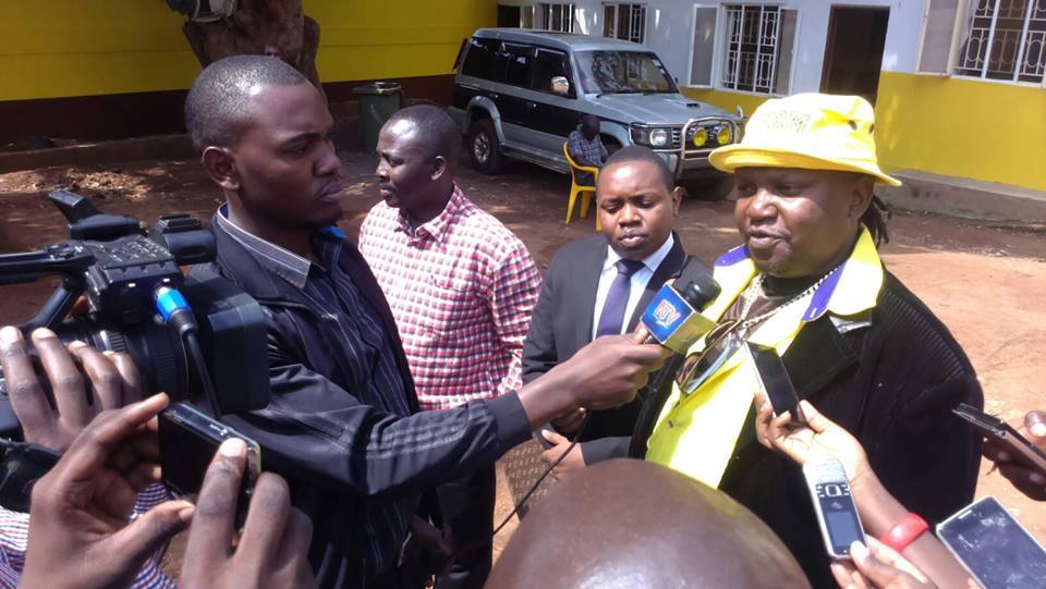 Ragga Dee addressing the press shortly after picking the forms at NRM party headquarters.
