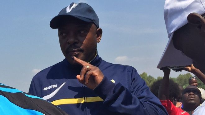 Incumbent President Pierre Nkurunziza displays his finger after casting his vote.