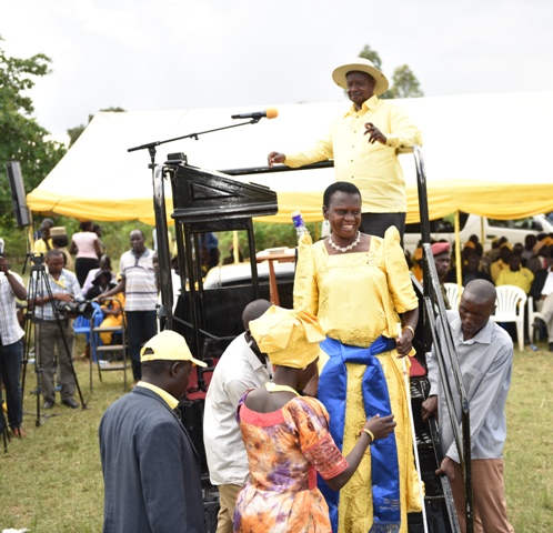 Hon Babadiri is guidede down the presidential podium after addresseing NRM supporters during President Museveni's rally in Koboko North County yesterday Nov 18. PPU Photo